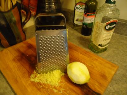 Chopping block with a grater and grated lemon